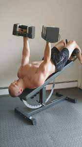 man using DB incline weight bench